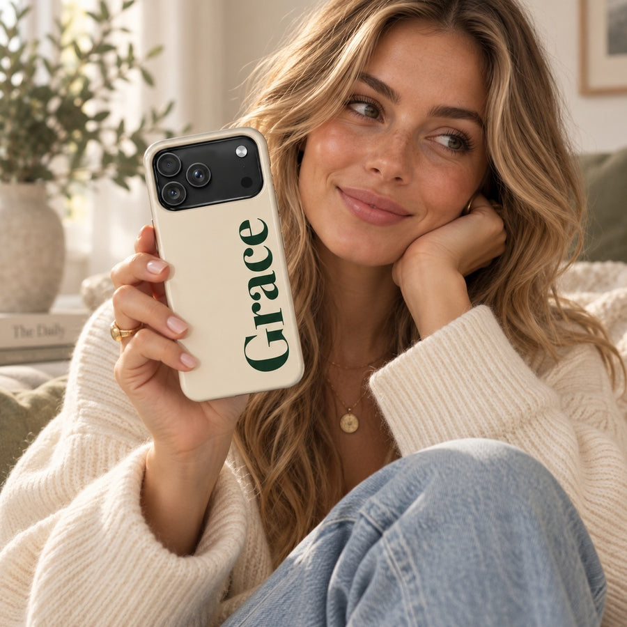 Cream name case printed with the name Grace in dark green serif lettering, held by a smiling woman